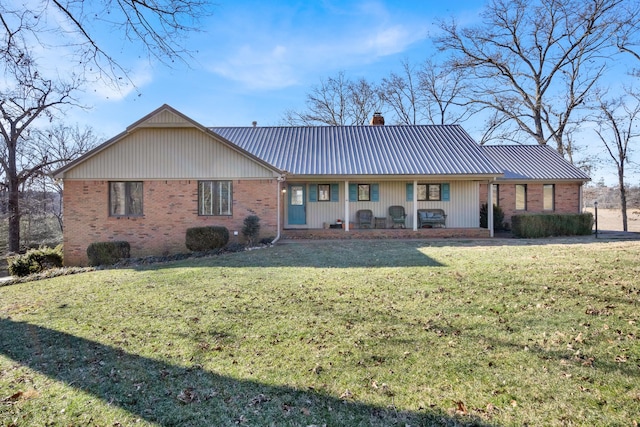 back of property featuring a yard