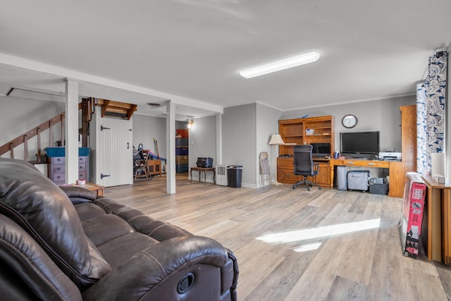 living room with ornamental molding and light hardwood / wood-style flooring