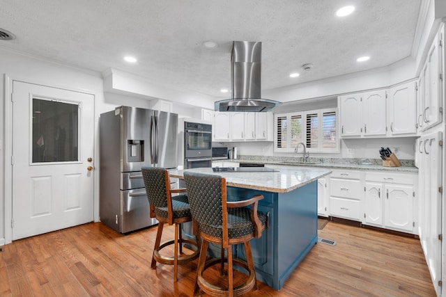 kitchen with white cabinetry, island range hood, stainless steel appliances, a center island, and sink