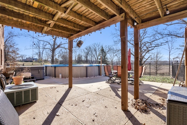 view of patio / terrace featuring central AC and a swimming pool with hot tub