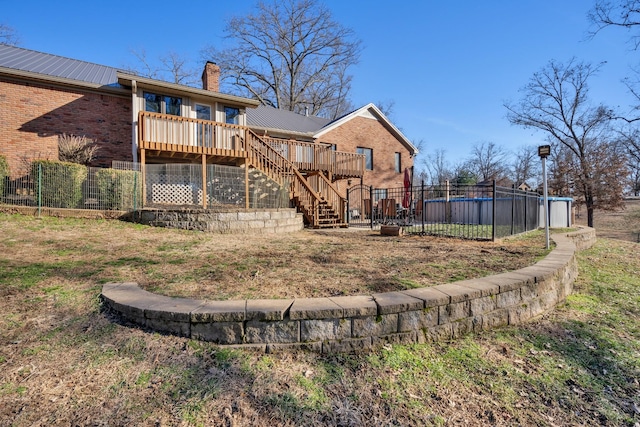 back of property with a swimming pool side deck