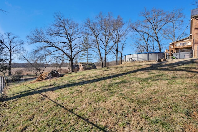 view of yard with a swimming pool side deck