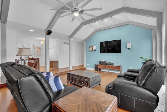 living room featuring hardwood / wood-style flooring, lofted ceiling, and ceiling fan