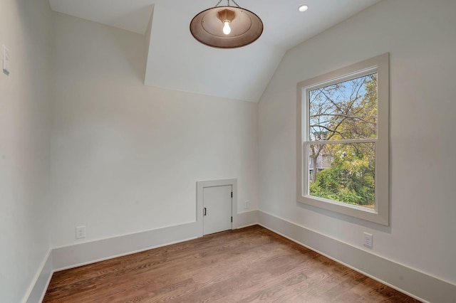 bonus room featuring lofted ceiling and light hardwood / wood-style floors