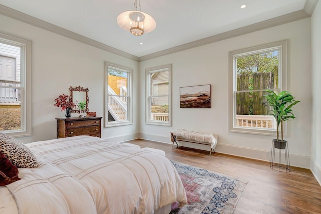 bedroom with wood-type flooring and ornamental molding