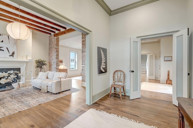 hallway featuring crown molding, hardwood / wood-style flooring, and beamed ceiling