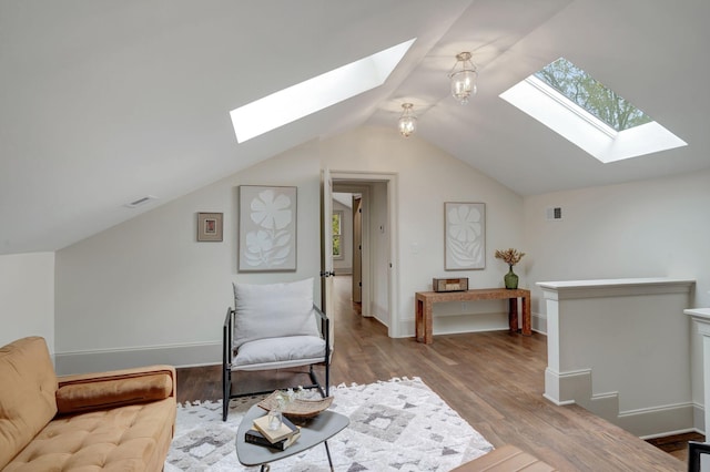 living area with vaulted ceiling and light hardwood / wood-style floors