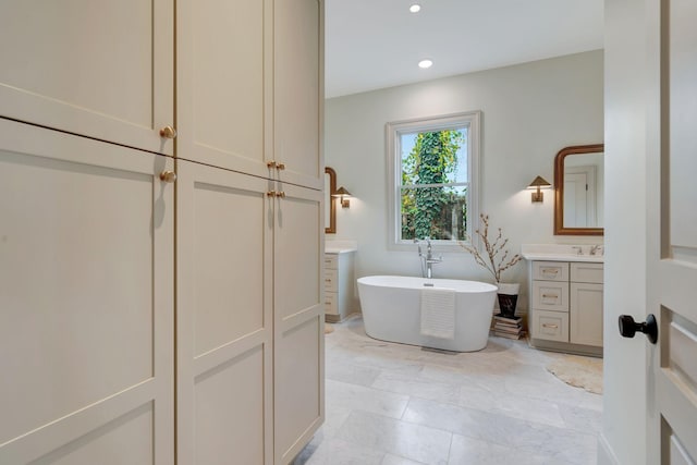 bathroom with vanity and a tub