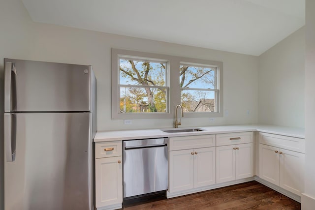 kitchen featuring stainless steel appliances, white cabinetry, sink, and dark hardwood / wood-style floors