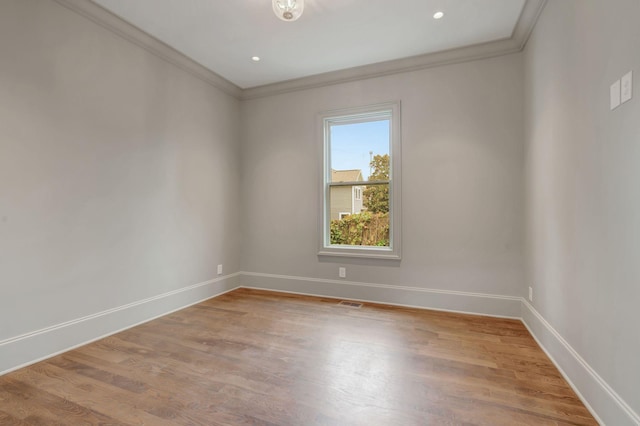 unfurnished room with crown molding and light hardwood / wood-style floors