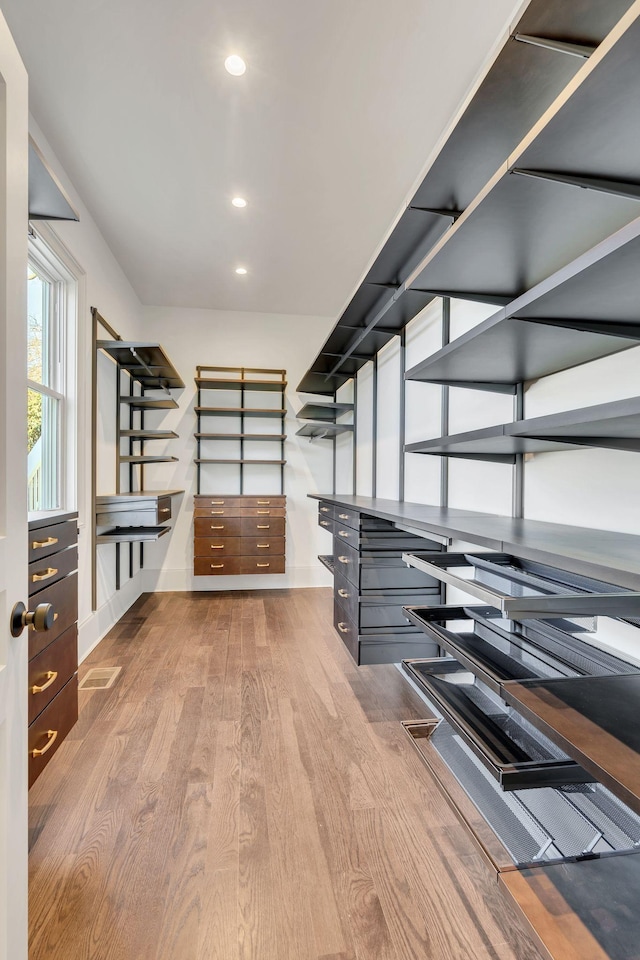 walk in closet featuring light hardwood / wood-style flooring