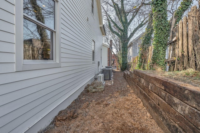 view of side of home featuring central AC