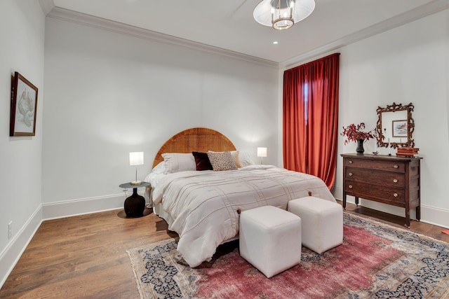 bedroom with hardwood / wood-style flooring and ornamental molding