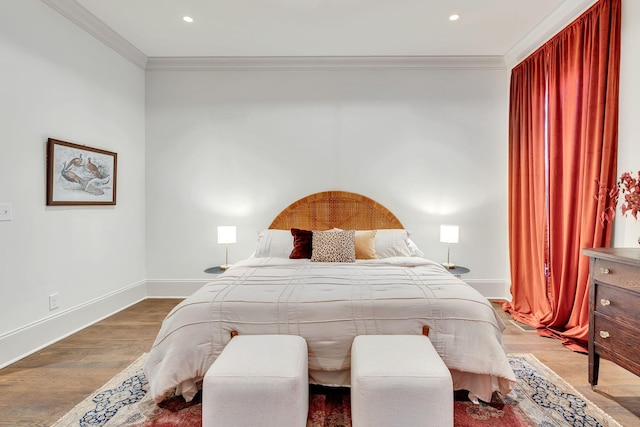 bedroom with hardwood / wood-style flooring and ornamental molding