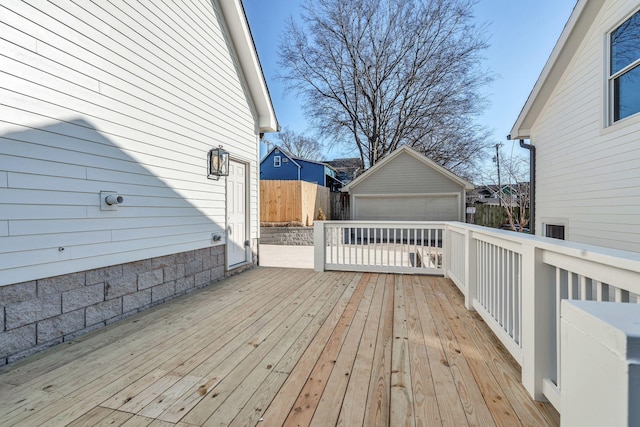 deck with a garage and an outdoor structure