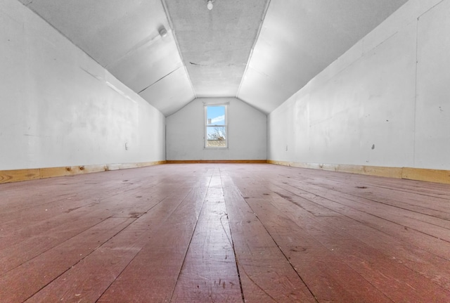 additional living space featuring hardwood / wood-style flooring and lofted ceiling