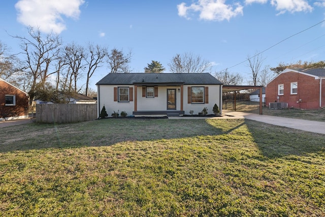 ranch-style house with central AC unit, a front lawn, a porch, and a carport