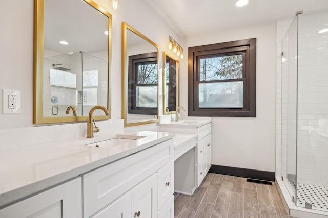 bathroom with vanity and a shower with door