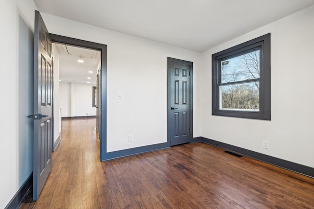 unfurnished room featuring dark hardwood / wood-style flooring