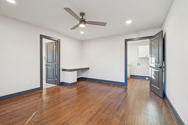 unfurnished room with ceiling fan and dark hardwood / wood-style floors