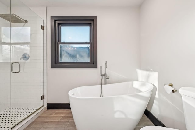 bathroom featuring toilet and independent shower and bath