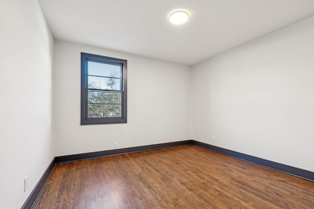 empty room featuring dark hardwood / wood-style flooring