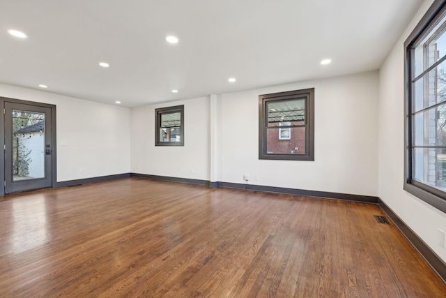 spare room with dark wood-type flooring