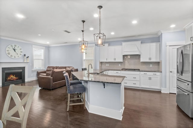 kitchen with sink, white cabinets, pendant lighting, and appliances with stainless steel finishes