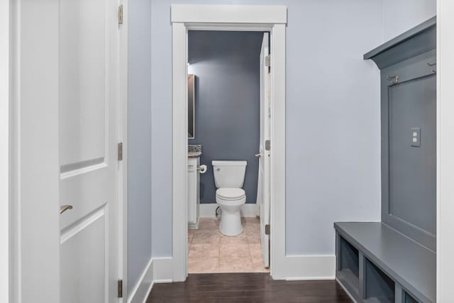 bathroom with hardwood / wood-style floors, toilet, and vanity