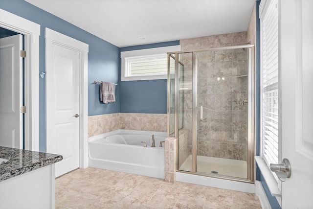 bathroom featuring vanity and shower with separate bathtub