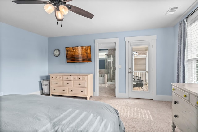 bedroom with ceiling fan, light colored carpet, and ensuite bath