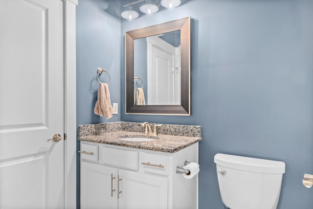 bathroom with toilet and vanity