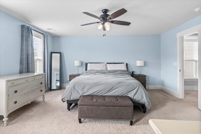 bedroom with ceiling fan and light carpet