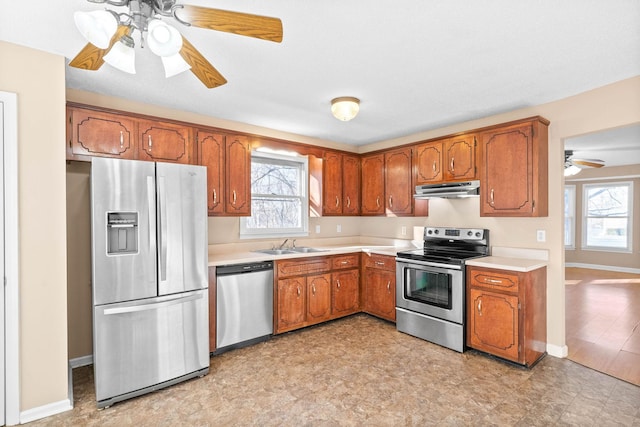 kitchen featuring ceiling fan, appliances with stainless steel finishes, and sink