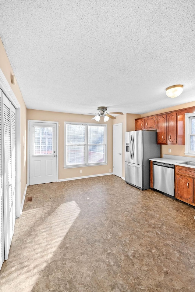 kitchen with ceiling fan, stainless steel appliances, and sink