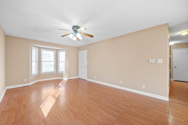 unfurnished room featuring ceiling fan and light hardwood / wood-style flooring