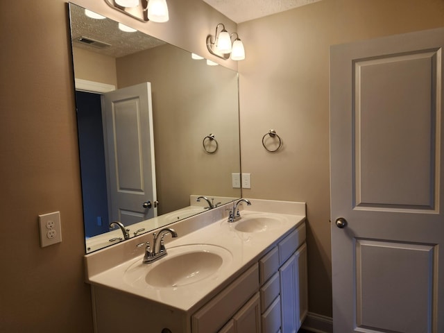 bathroom featuring vanity and a textured ceiling