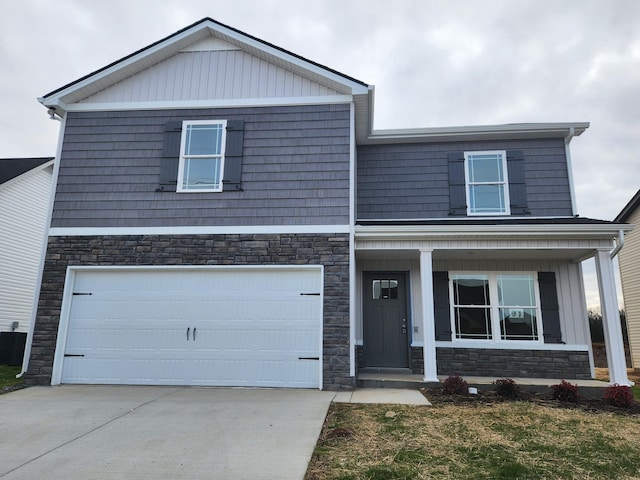 view of front of home featuring central air condition unit, a porch, and a garage