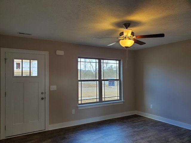 entryway with a textured ceiling, ceiling fan, and dark hardwood / wood-style floors