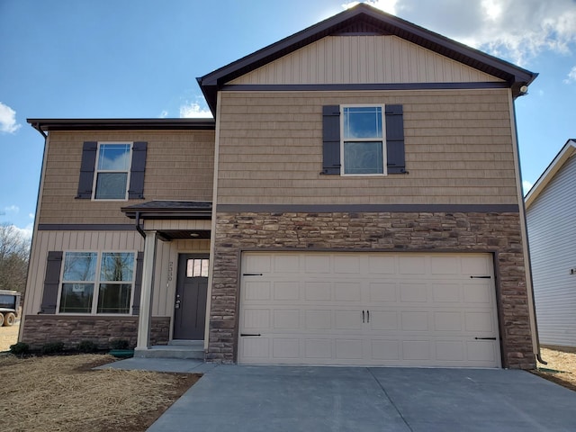 traditional home with stone siding, driveway, and a garage