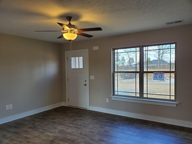 entryway featuring dark wood-type flooring and ceiling fan