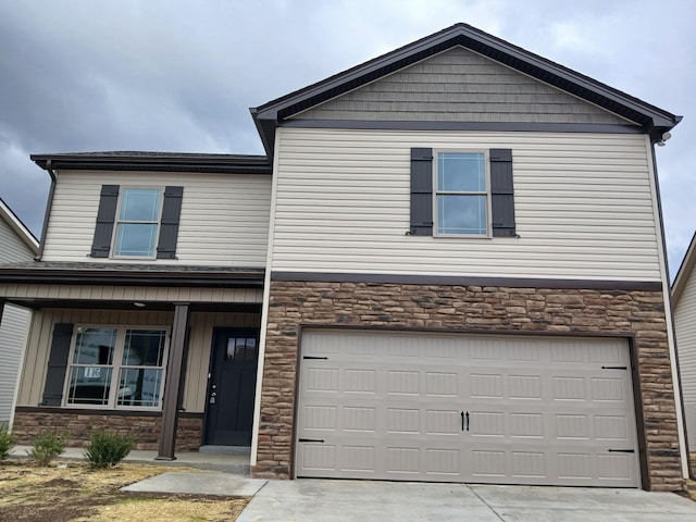 view of front facade with stone siding, driveway, and a garage