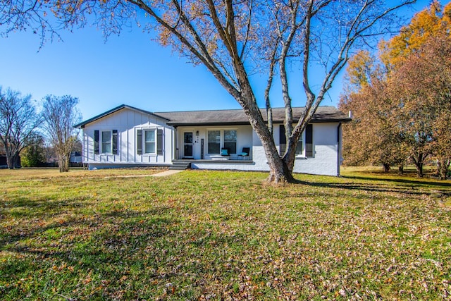 view of front of property featuring board and batten siding and a front lawn