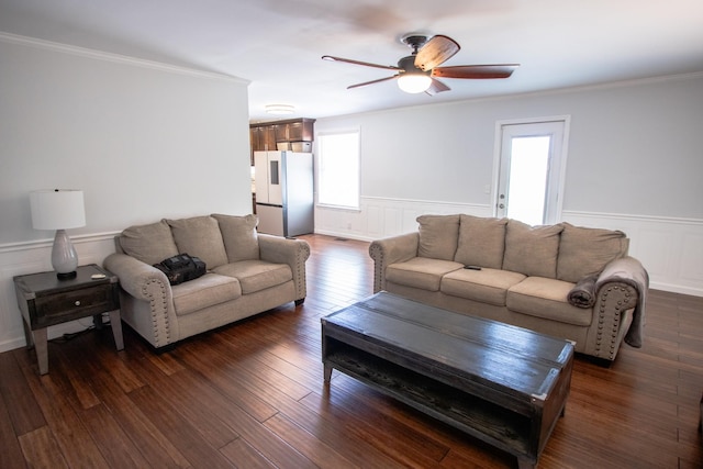 living room featuring ceiling fan, ornamental molding, and dark hardwood / wood-style flooring