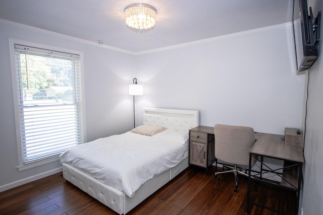 bedroom featuring dark hardwood / wood-style floors, crown molding, and a notable chandelier