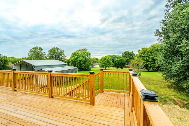 deck with a carport and a lawn