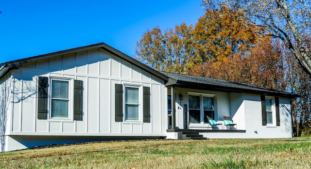 view of home's exterior featuring a lawn and board and batten siding