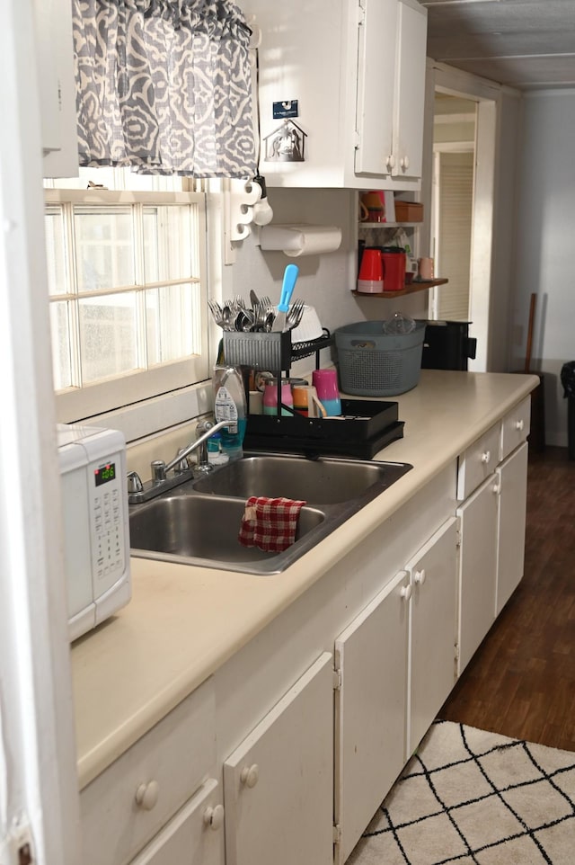 kitchen featuring sink, white cabinets, and dark hardwood / wood-style floors