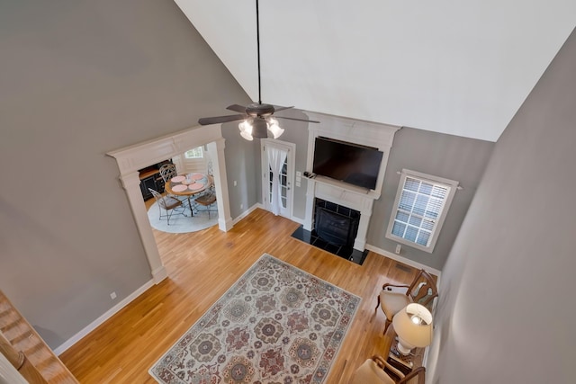 living room featuring high vaulted ceiling, plenty of natural light, wood-type flooring, and ceiling fan