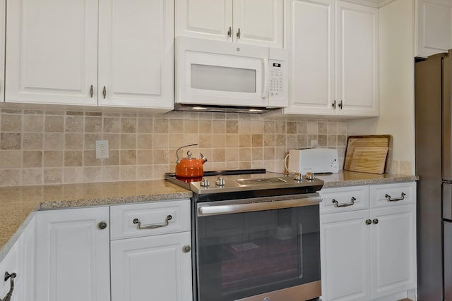 kitchen featuring light stone counters, white cabinetry, appliances with stainless steel finishes, and tasteful backsplash